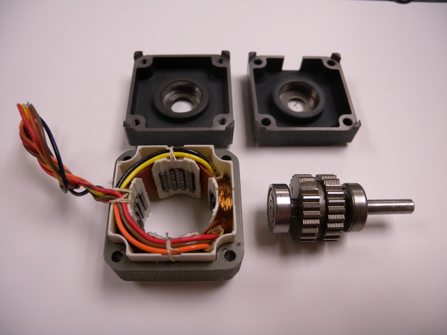 A stepper motor has a multitoothed rotor that is pulled in line with a series of coils.