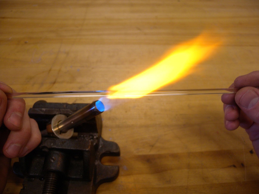 Roll the rod in the flame until it begins to wilt and then carefully pull it into a 1 mm filament.