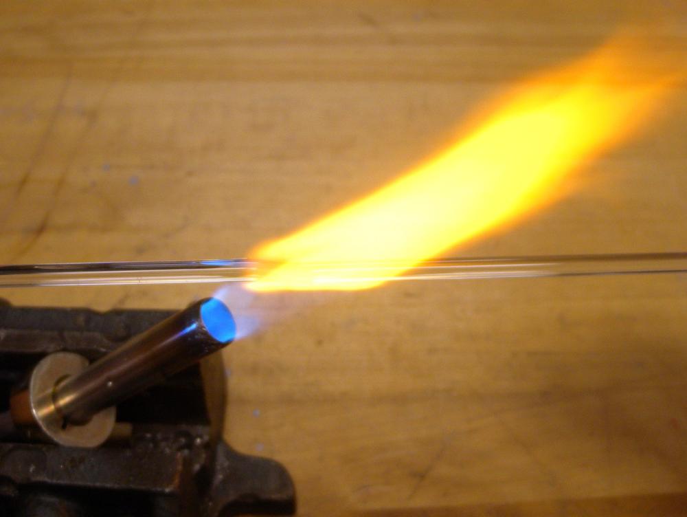 Remove the glass from the flame as soon as you create a 3 to 4 mm ball lens. If the lens grows too big, it might fall off of the filament.