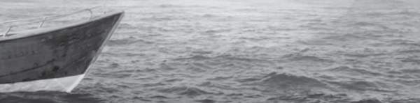 A closeup view of a boat floating on a lake.