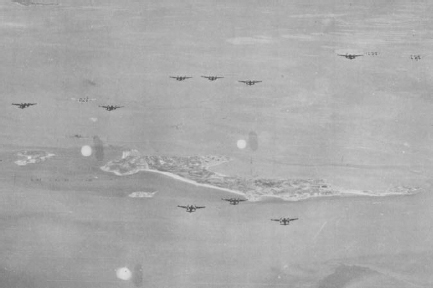 The photo shows B-26s flying over Cho-do toward North Korea (seen in the background).