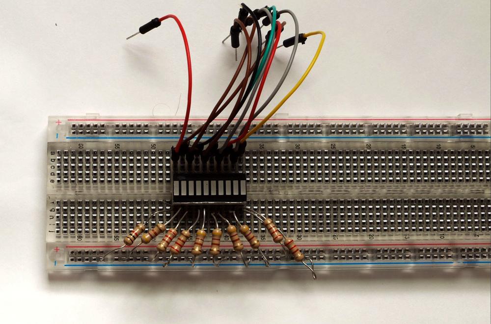 An LED bar display plugged into a breadboard, along with jumper wires to connect it to Arduino. You can also create an LED bar display using individual LEDs, as seen in the breadboard view.