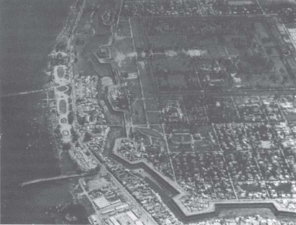 Aerial view of the southeast corner of the Citadel fortress of Hue. This photo was taken sometime after the NVA destroyed the main Highway One bridge, which is clearly seen in the lower left-hand corner of the photo. The Imperial Palace, the “inner fortress” of the Citadel, is also clearly seen in the upper right-hand corner. Most of the fighting inside the Citadel’s geometrically shaped outer walls took place in the residential district directly below the Imperial Palace, lower right-hand corner of the photo. (U.S. Marine Corps photo)